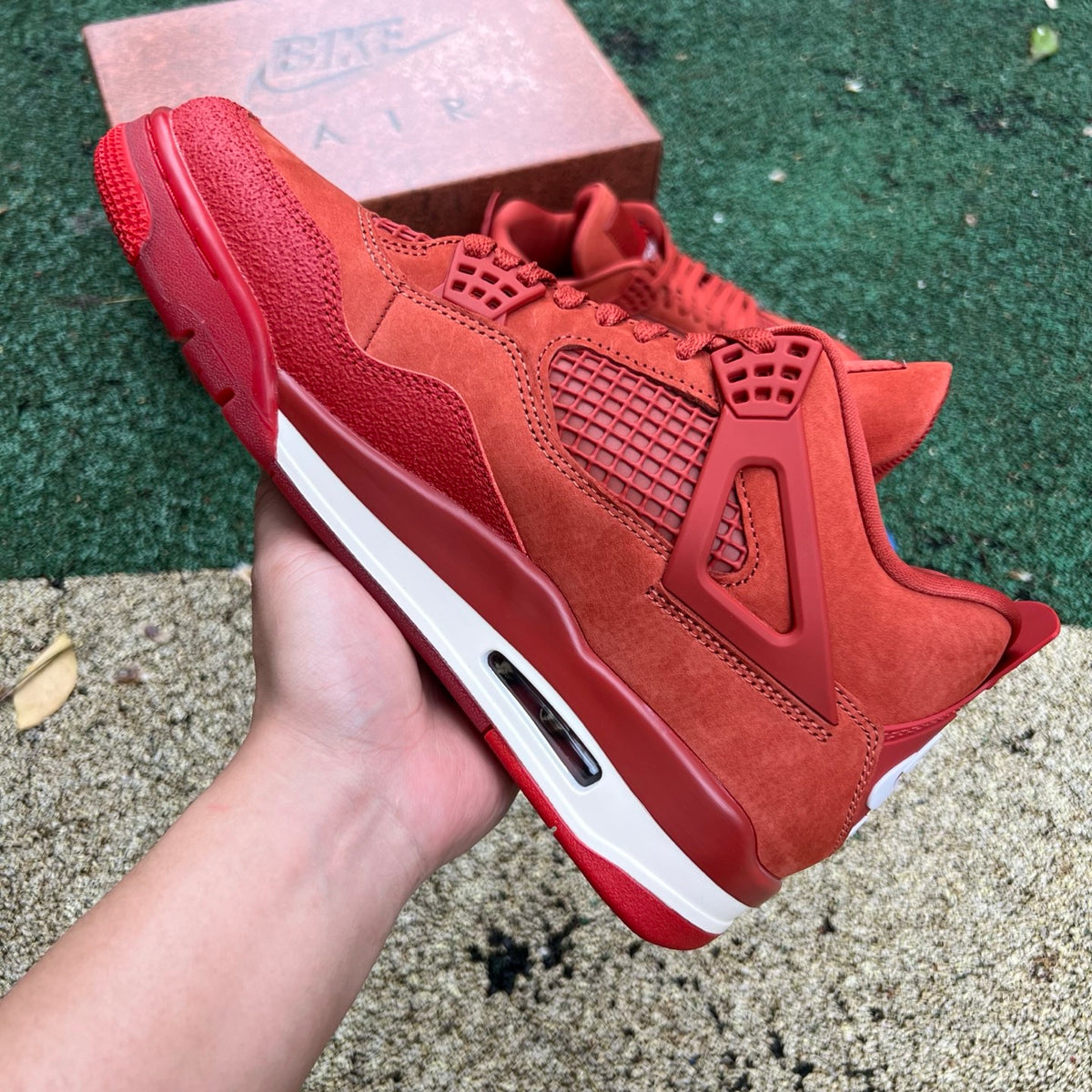 Nike Air Jordan 4 Retro OG SP Nigel Sylvester Brick by Brick sneakers in black and red with distinctive design details.