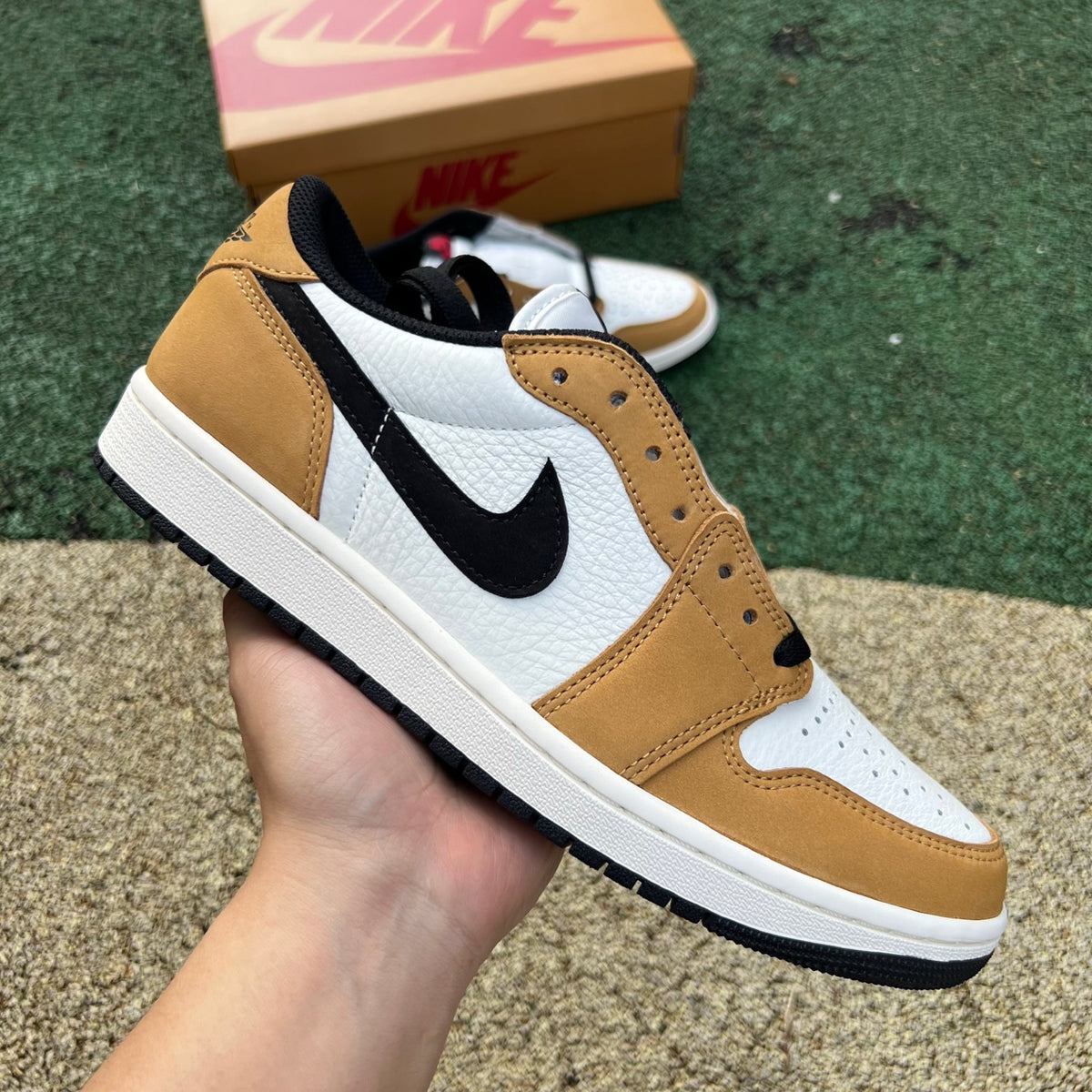 Nike Air Jordan 1 Low OG Rookie of the Year sneakers in white, black, and gold with classic low-top design and Nike branding