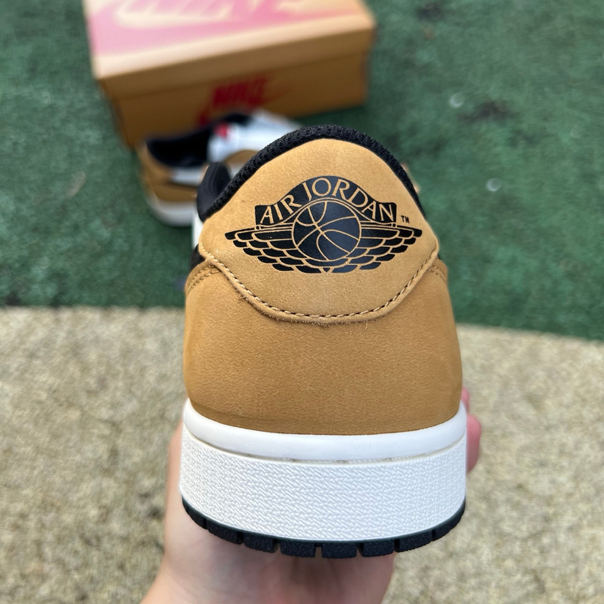 Nike Air Jordan 1 Low OG Rookie of the Year sneakers in black, white, and red with classic Nike and Jordan branding.