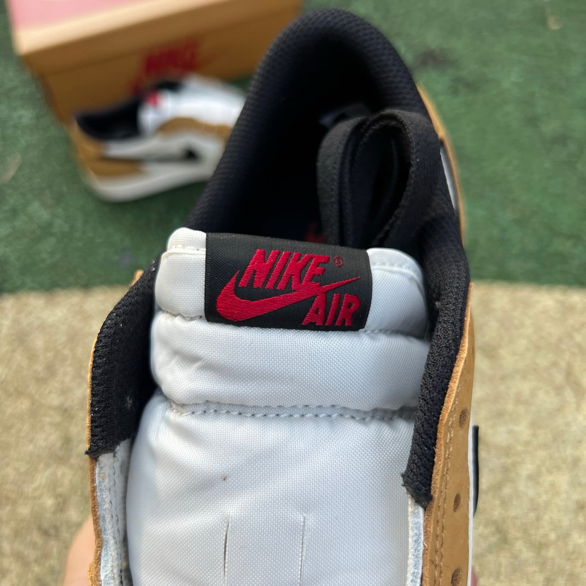 Nike Air Jordan 1 Low OG Rookie of the Year sneakers in black and white with Nike swoosh and low-top design, front view.