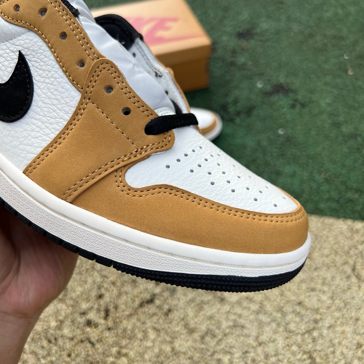 Nike Air Jordan 1 Low OG Rookie of the Year sneakers in black and white with Nike and Jordan branding visible.