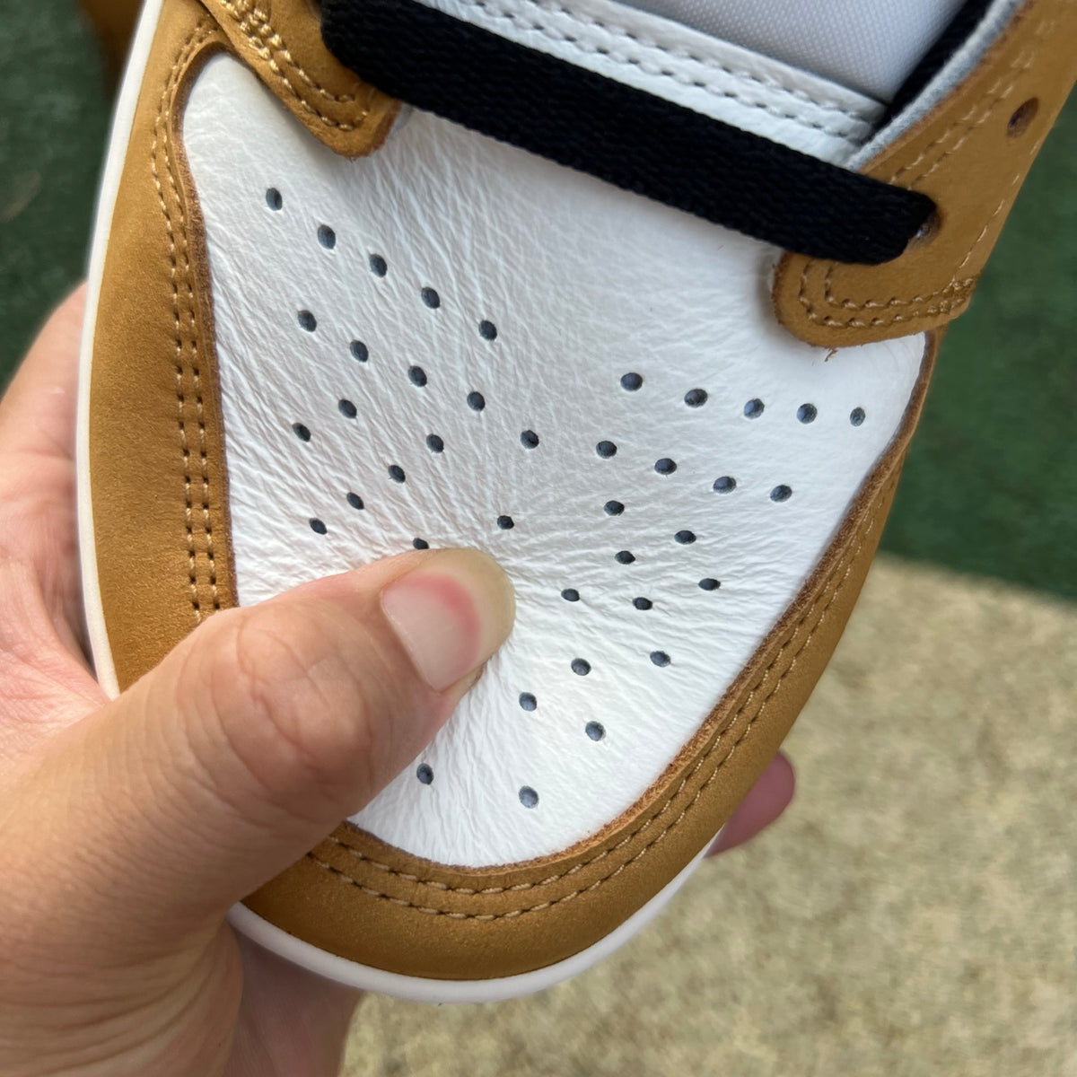Nike Air Jordan 1 Low OG Rookie of the Year sneakers in white and black with Nike swoosh and Jordan branding.