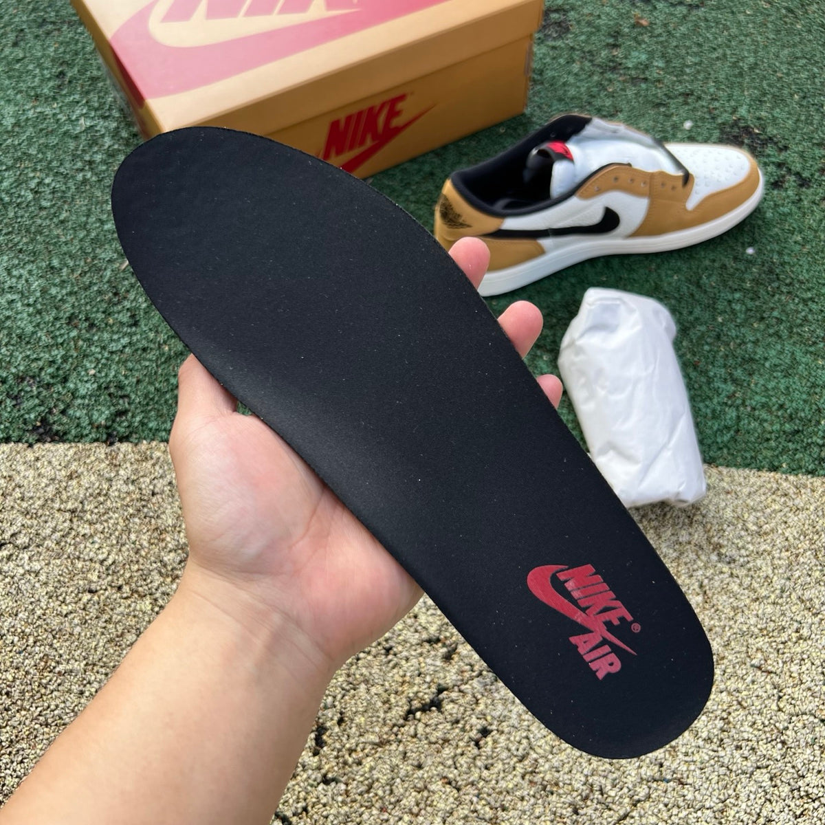 Nike Air Jordan 1 Low OG Rookie of the Year sneakers in black and white with Nike swoosh and low-top design.