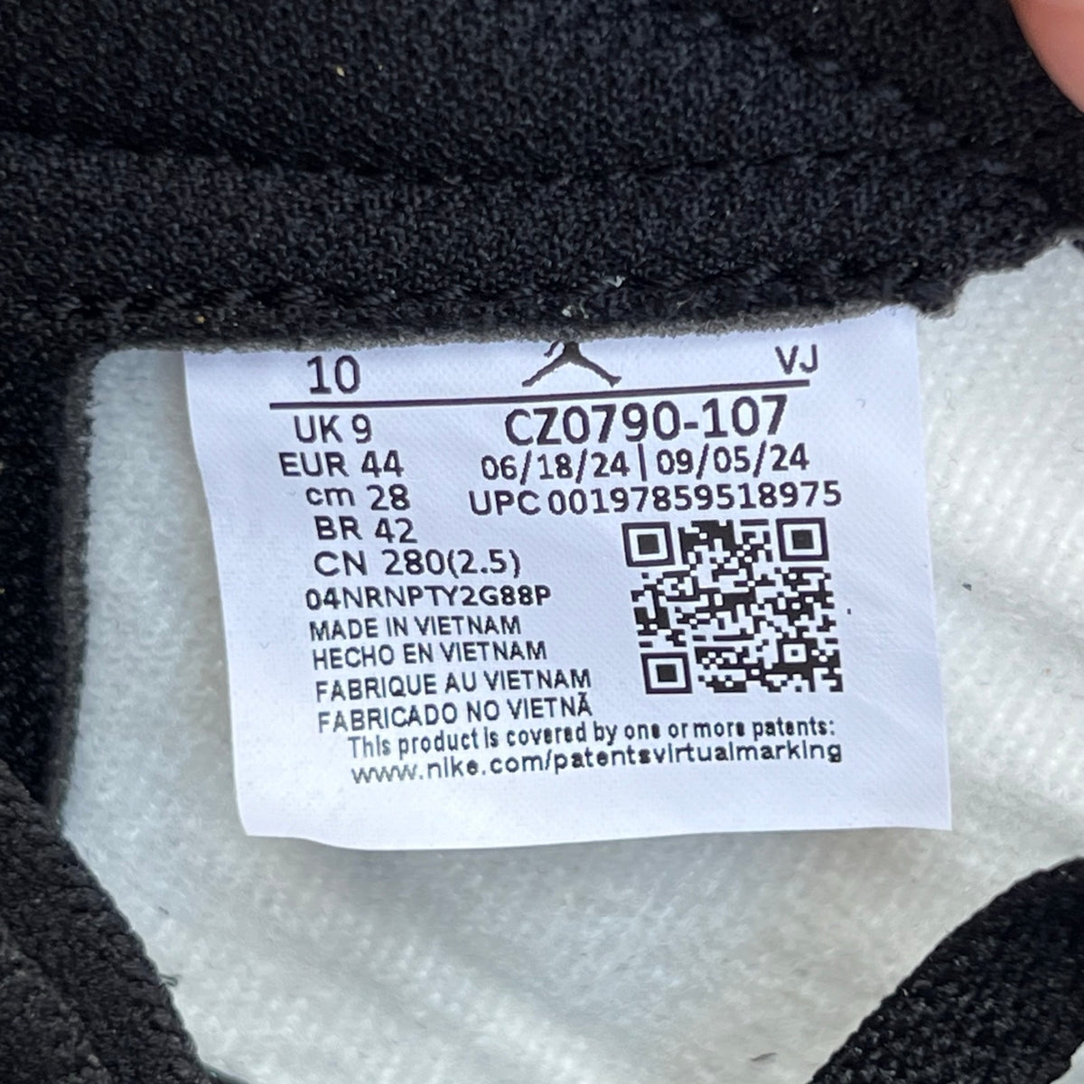 Nike Air Jordan 1 Low OG Rookie of the Year sneaker in black and white with Nike and Jordan branding, showing the side view.