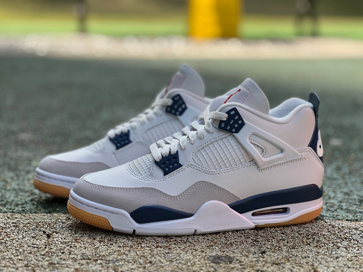 Nike Air Jordan 4 Retro SB sneakers in navy with white accents, featuring classic Jordan design and branding.