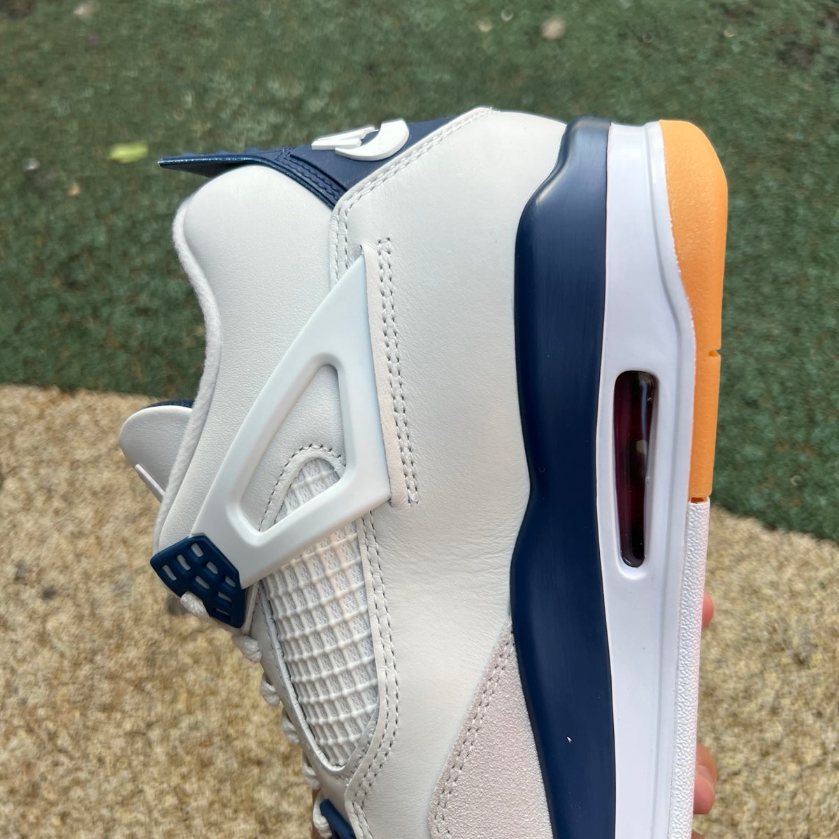 Nike Air Jordan 4 Retro SB sneakers in navy with white accents, featuring textured suede and classic design elements.