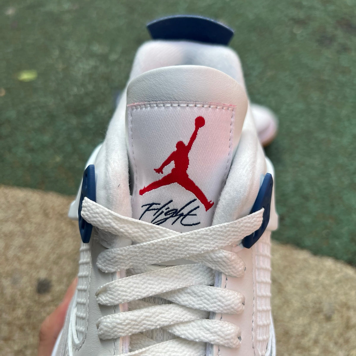 Nike Air Jordan 4 Retro SB sneakers in navy with white accents, featuring classic design and Nike x Jordan branding.
