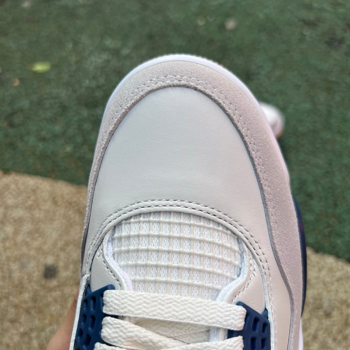 Nike Air Jordan 4 Retro SB sneakers in navy with white accents, featuring Nike x Jordan branding and classic design details.