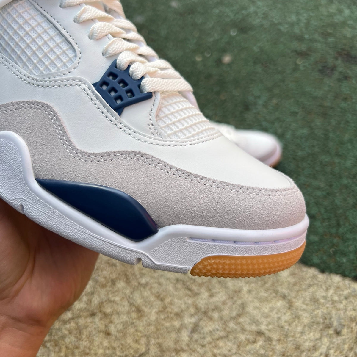 Nike Air Jordan 4 Retro SB sneakers in navy with white accents, featuring signature design details and classic Jordan branding.