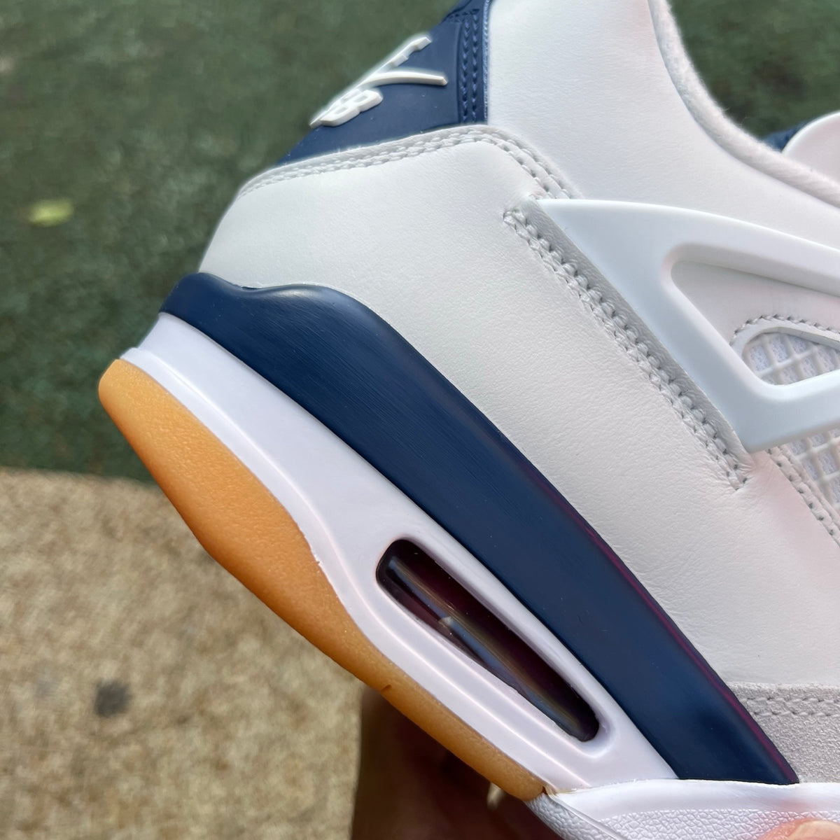 Nike Air Jordan 4 Retro SB Navy sneakers with white and navy colorway, featuring classic design and signature branding.