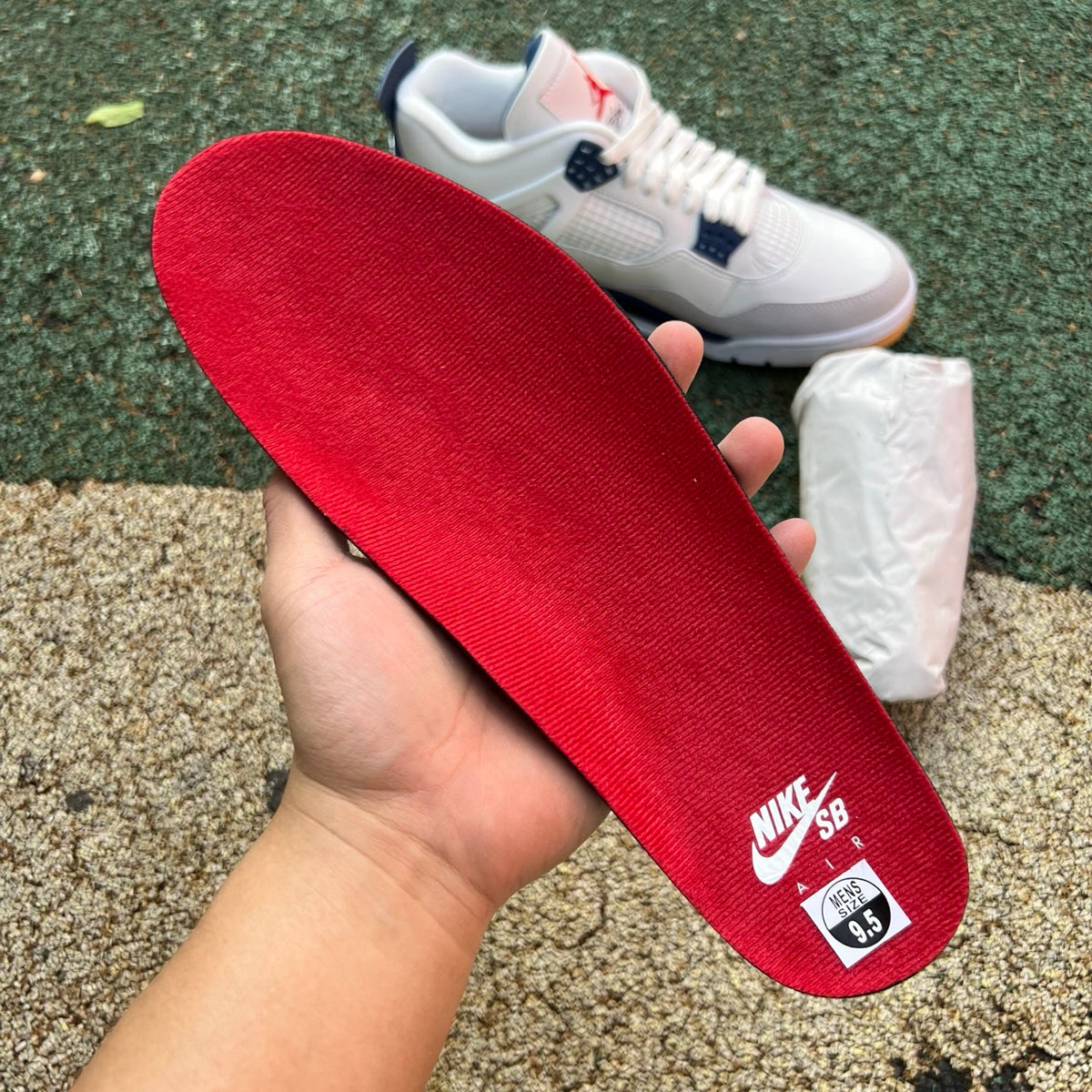 Nike Air Jordan 4 Retro SB sneakers in navy with white accents, showcasing the classic basketball shoe design.