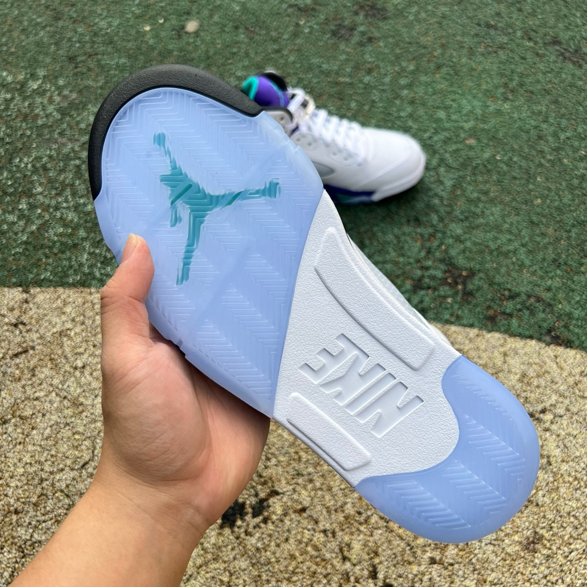 Nike Air Jordan 5 Retro Grape sneakers in purple and black with white accents, showcasing the iconic basketball shoe design.