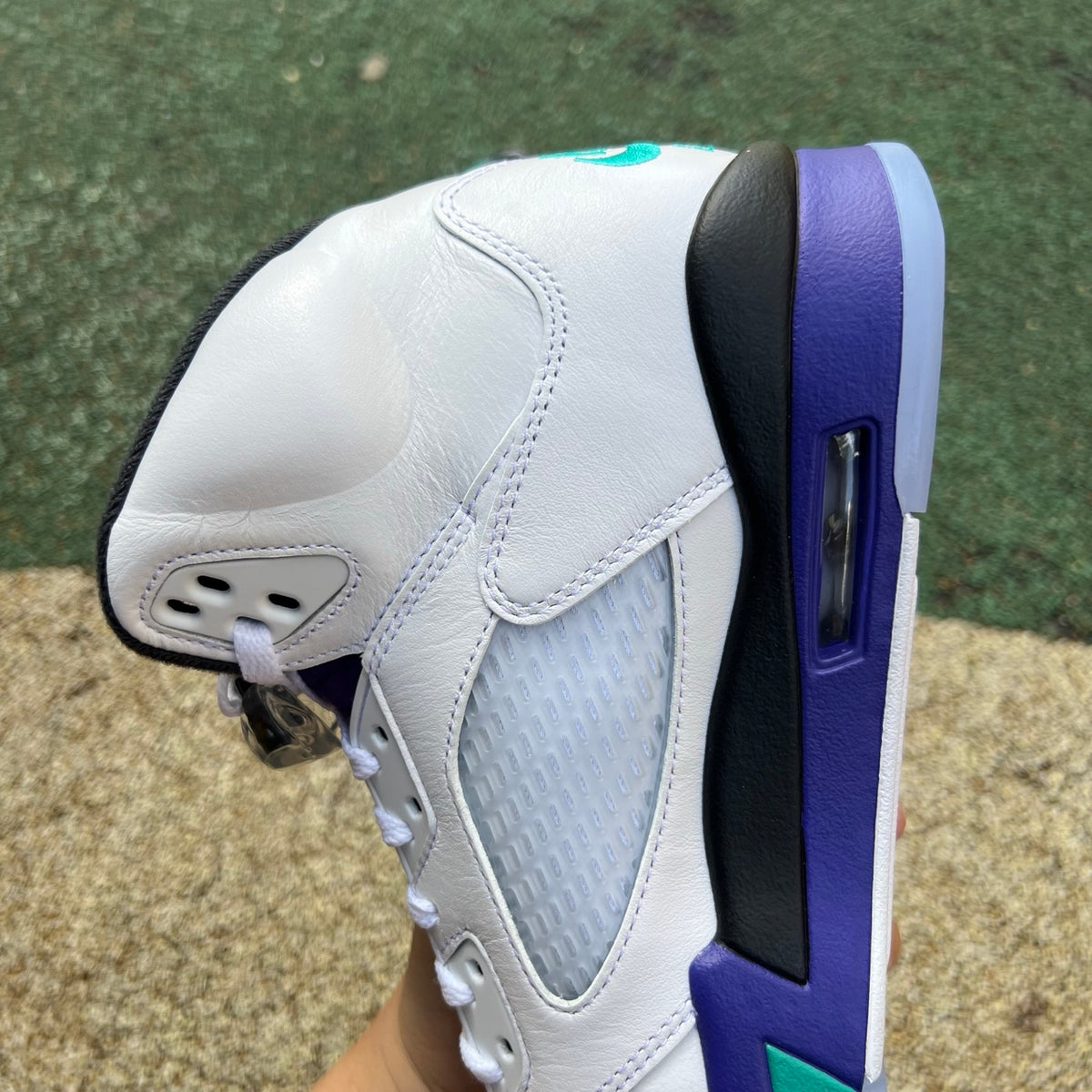 Nike Air Jordan 5 Retro Grape sneakers in white, purple, and teal with black accents, featuring a classic design and premium materials.
