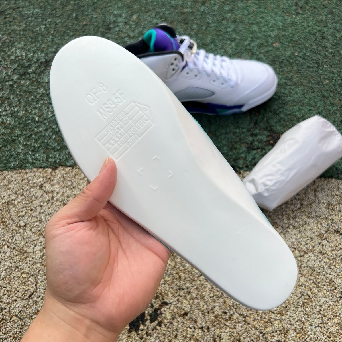 Nike Air Jordan 5 Retro Grape sneakers in white with purple and teal accents, front view showcasing the iconic design details.