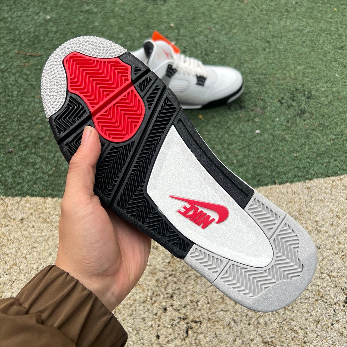 Nike Air Jordan 4 Retro White Cement sneakers, white leather with grey accents, showcasing the classic design and signature details.