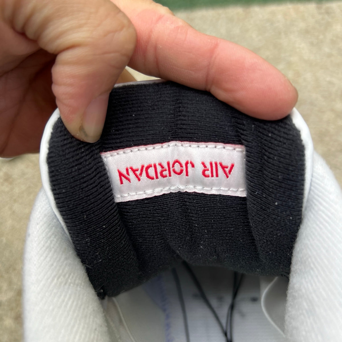 Nike Air Jordan 4 Retro White Cement sneakers, white and gray colorway, featuring signature design and Nike Jordan branding.