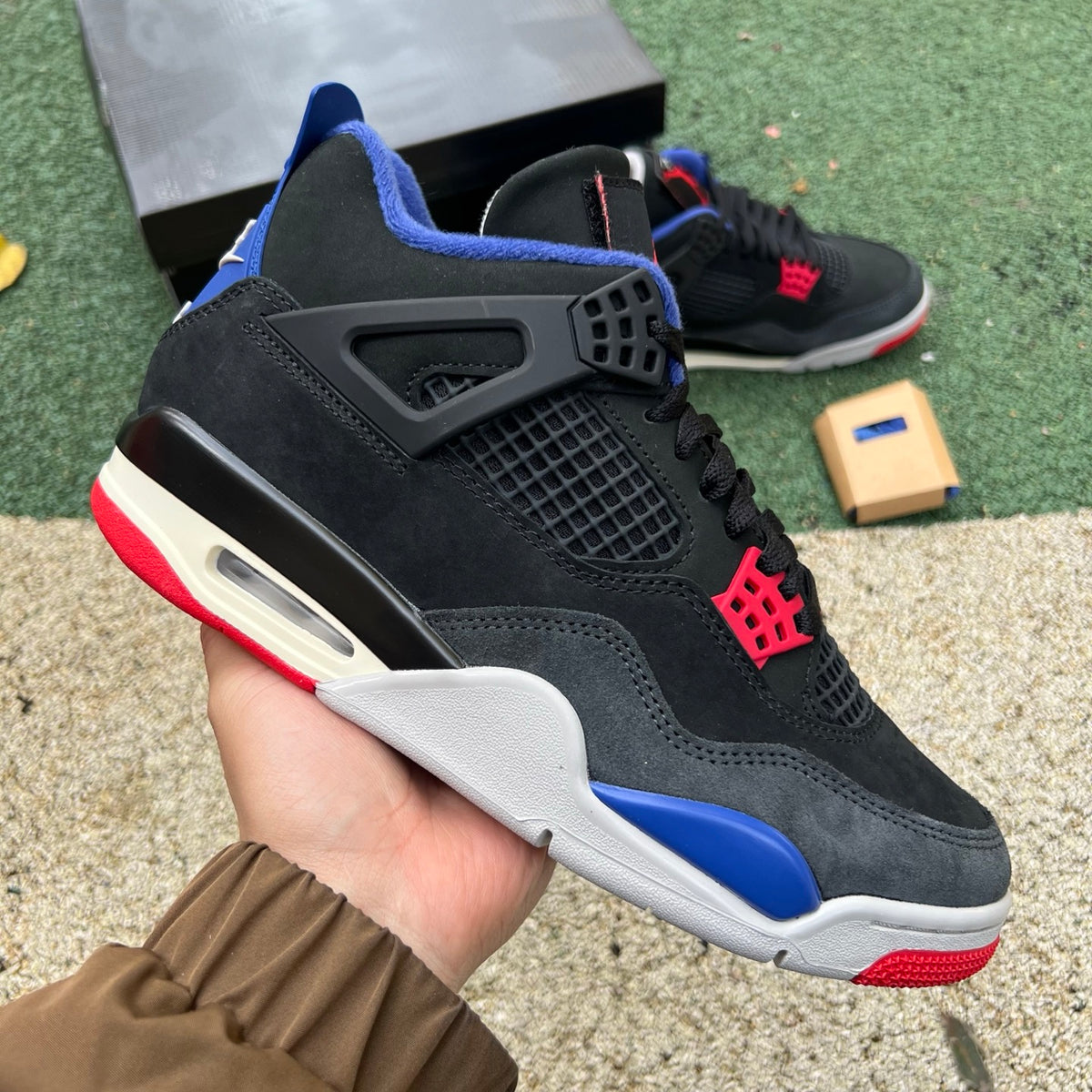 Nike Air Jordan 4 Retro Rare Air sneakers in white with distinctive lettering, featuring Nike x Jordan branding and classic design.
