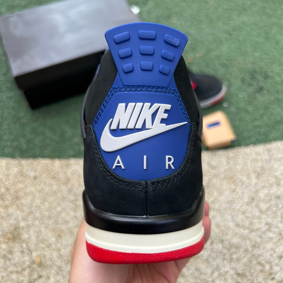 Nike Air Jordan 4 Retro Rare Air sneakers in white with lettering, featuring a classic design and Nike x Jordan branding.
