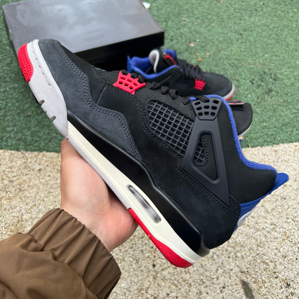 Nike Air Jordan 4 Retro Rare Air sneakers with white lettering, featuring classic Nike x Jordan branding and stylish design.