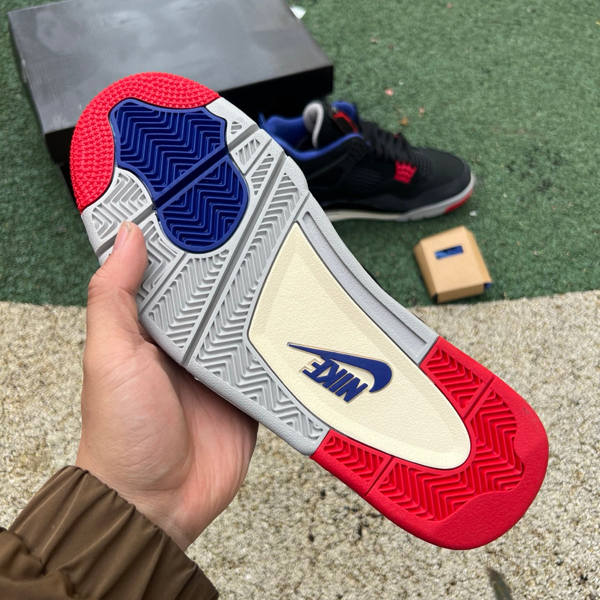 Nike Air Jordan 4 Retro Rare Air sneakers in white with black lettering, featuring iconic design and signature branding.