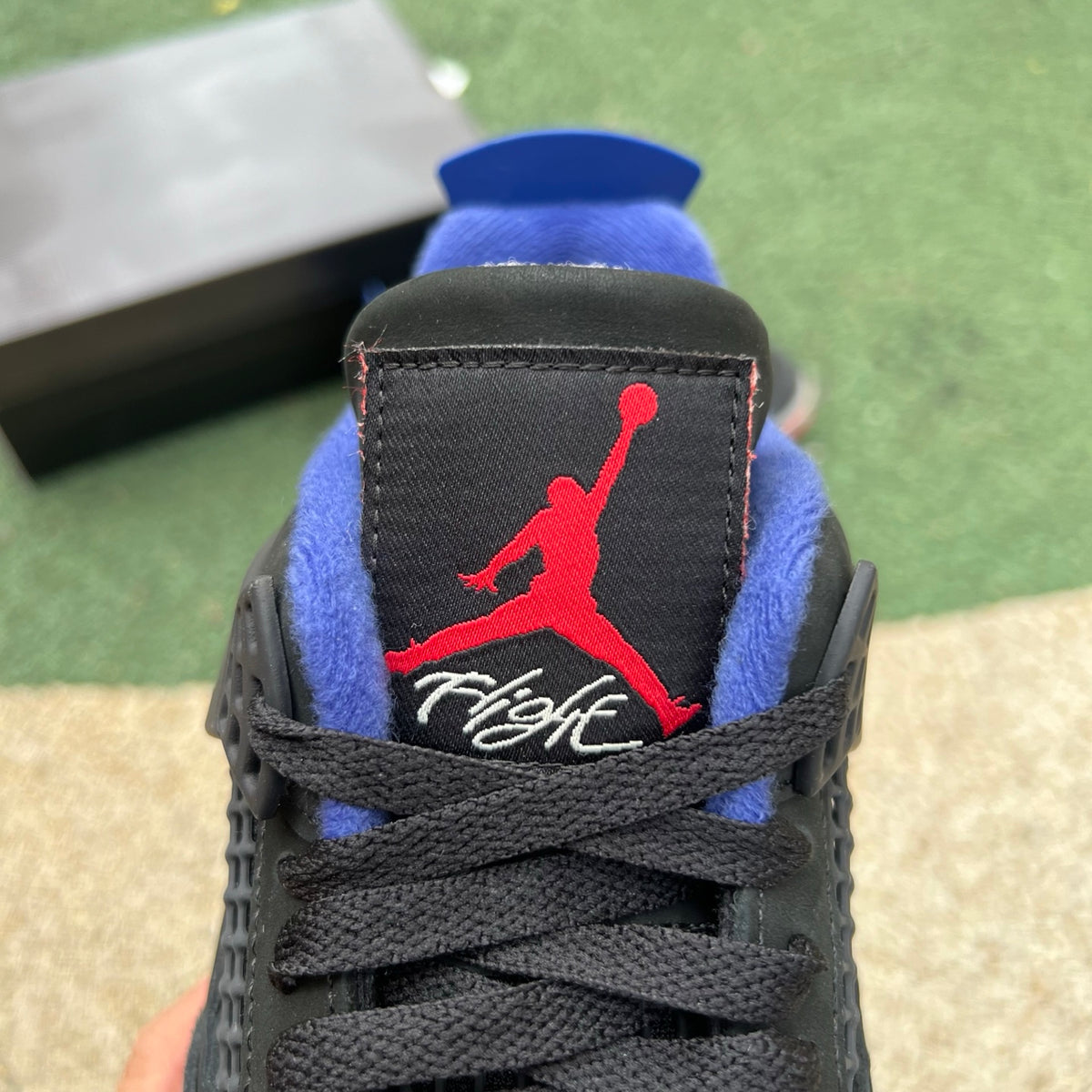 Nike Air Jordan 4 Retro Rare Air sneakers with white lettering, featuring classic design and signature branding.