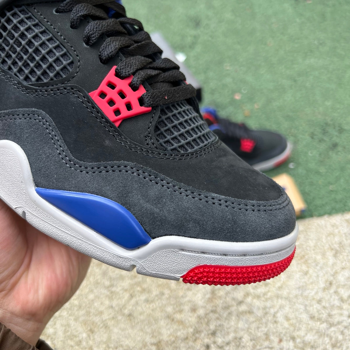 Nike Air Jordan 4 Retro Rare Air sneakers with white lettering, featuring classic design and Nike x Jordan branding.