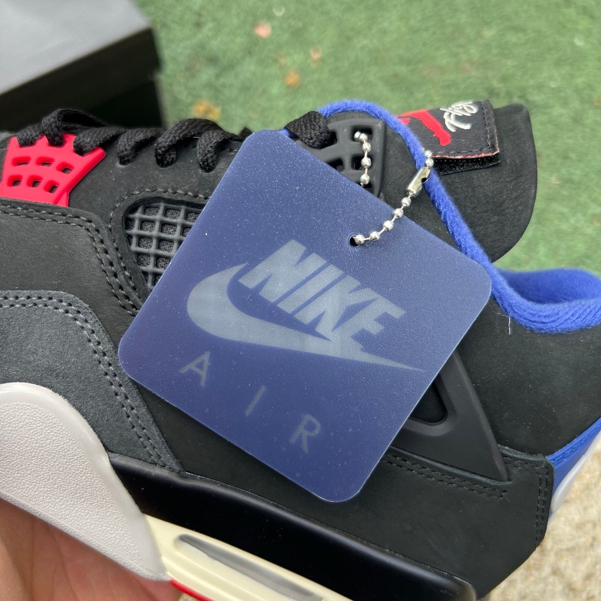 Nike Air Jordan 4 Retro Rare Air sneakers with white lettering, featuring a classic design and Nike x Jordan branding.