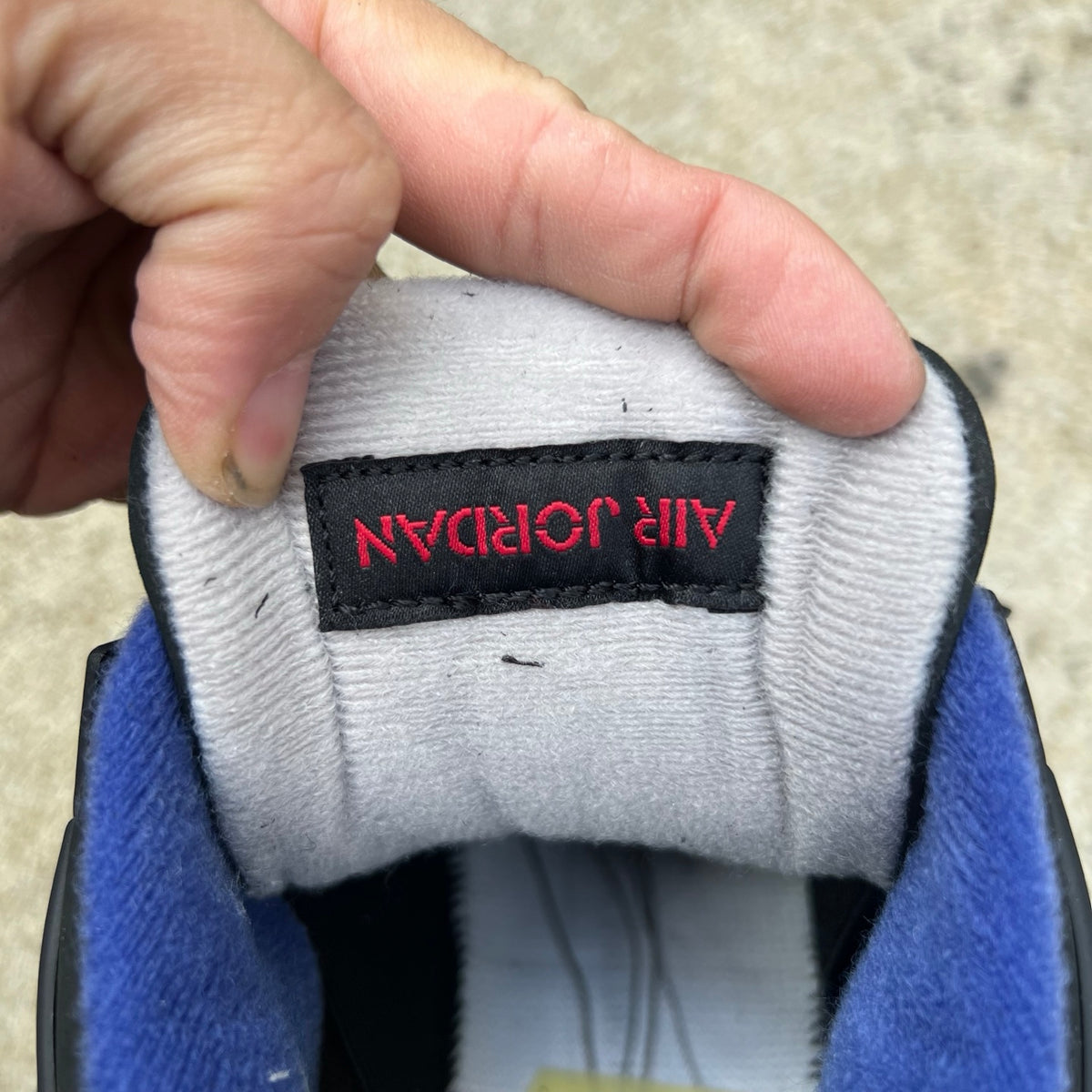 Nike Air Jordan 4 Retro sneakers with white lettering, featuring classic design and Nike x Jordan branding.