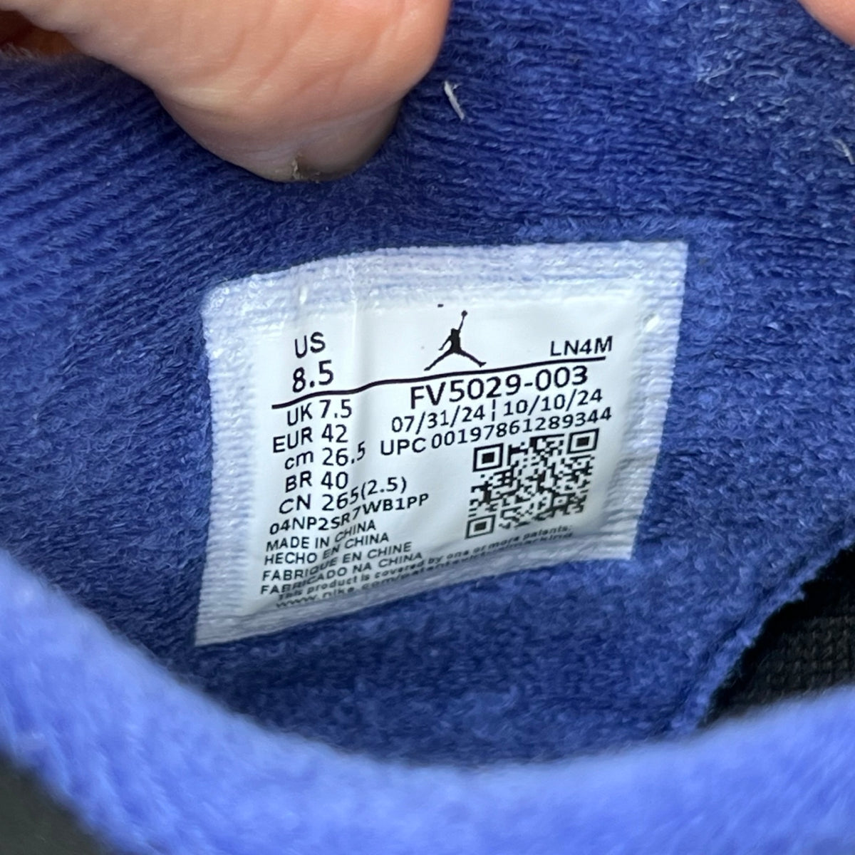 Nike Air Jordan 4 Retro Rare Air sneakers with white lettering, showcasing the iconic design and details of this classic basketball shoe