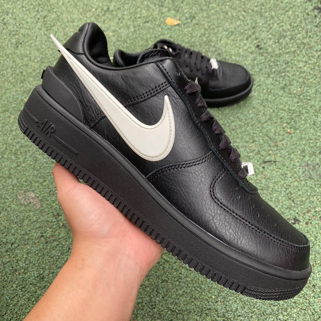 Nike Air Force 1 Low SP AMBUSH black sneakers with white accents, featuring a sleek design and Nike x Jordan branding