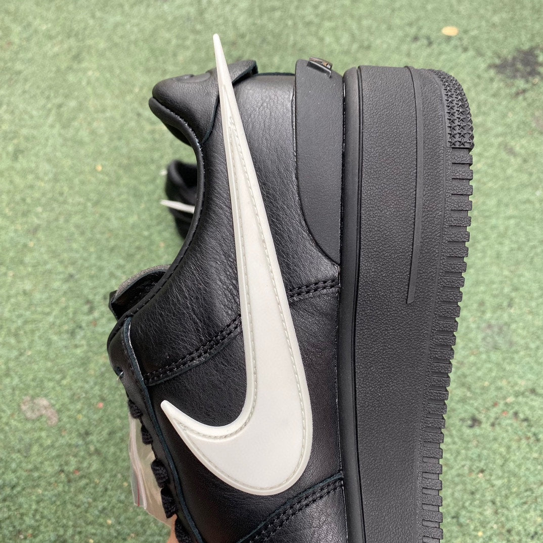 Nike Air Force 1 Low SP AMBUSH black sneakers with white accents, featuring a sleek design and Nike x Jordan branding.