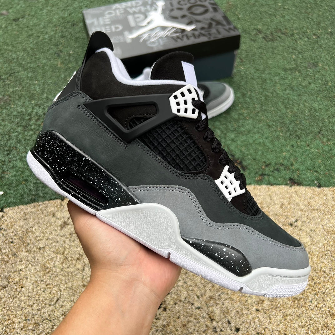 Nike Air Jordan 4 Retro Fear sneakers in black and orange with textured overlays and classic Jordan branding.