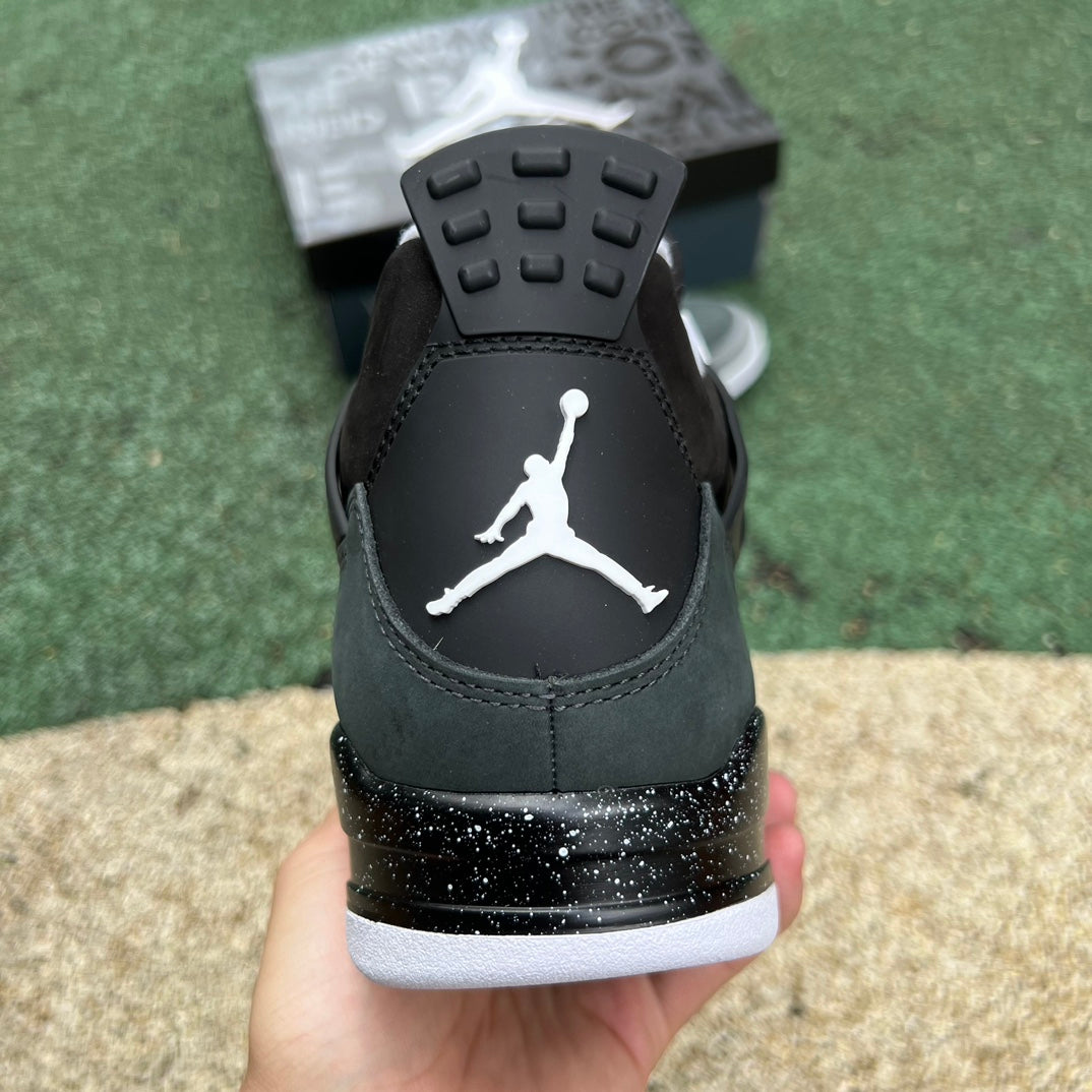 Nike Air Jordan 4 Retro Fear sneakers in black and red with white accents, featuring signature design details and Nike branding.