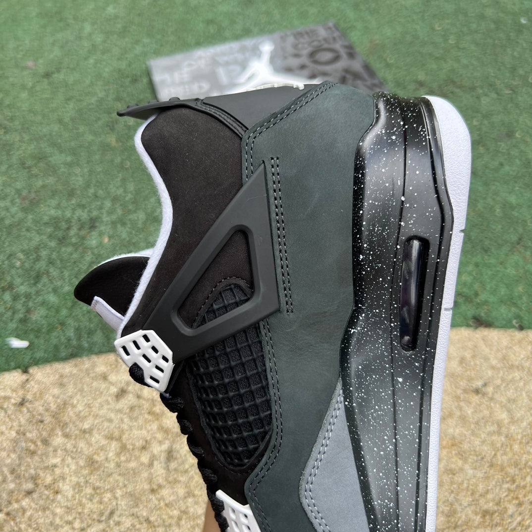 Nike Air Jordan 4 Retro Fear sneakers in black and purple with textured details, showcasing the iconic design and branding.