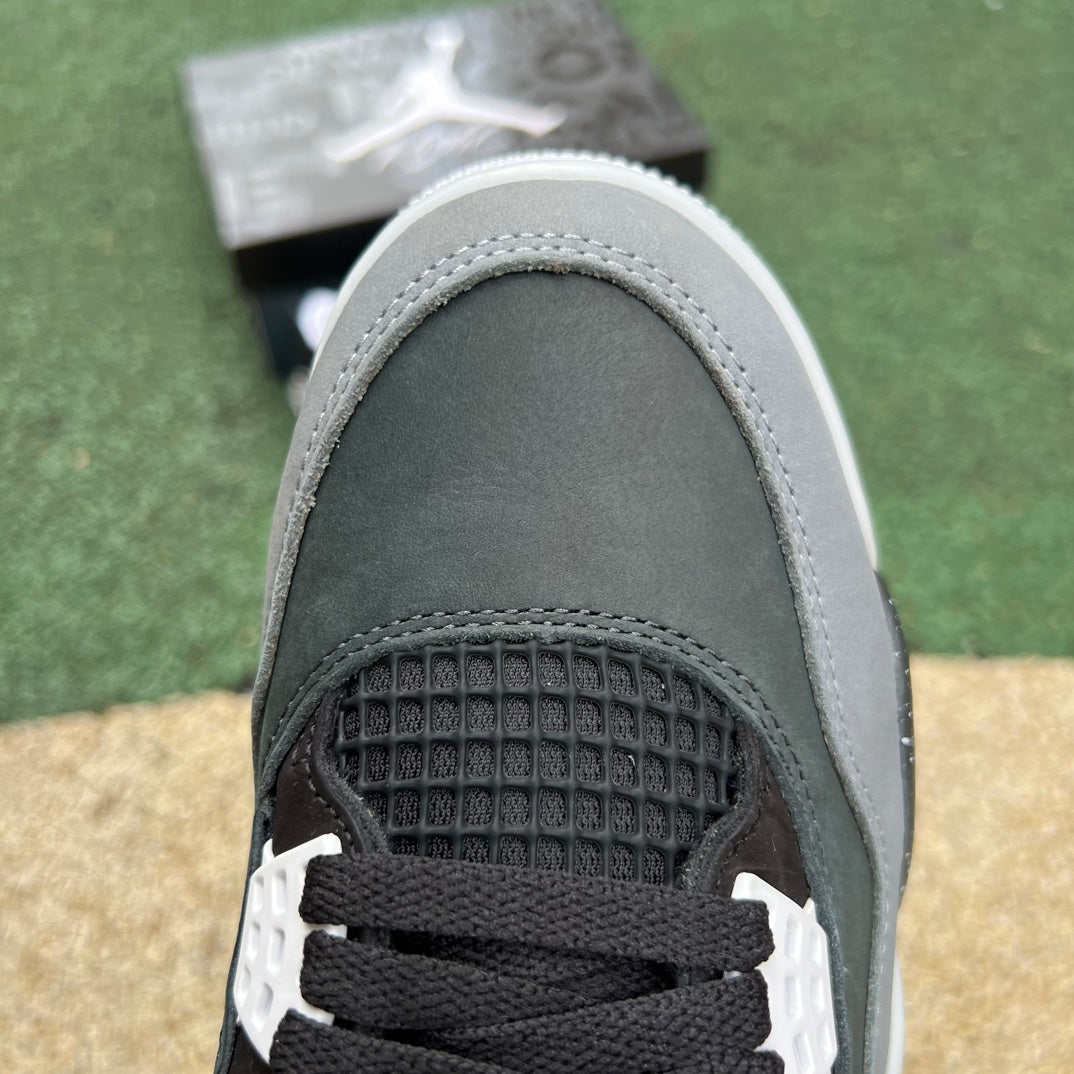 Nike Air Jordan 4 Retro Fear sneakers in black and purple, featuring signature design details and Nike x Jordan branding.