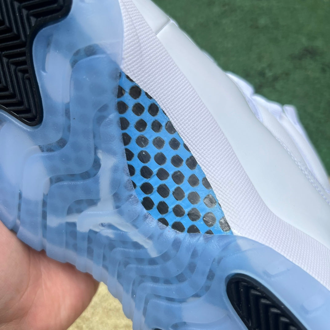 Nike Air Jordan 11 Retro Legend Blue sneakers in white and blue with patent leather, displayed on a plain background.