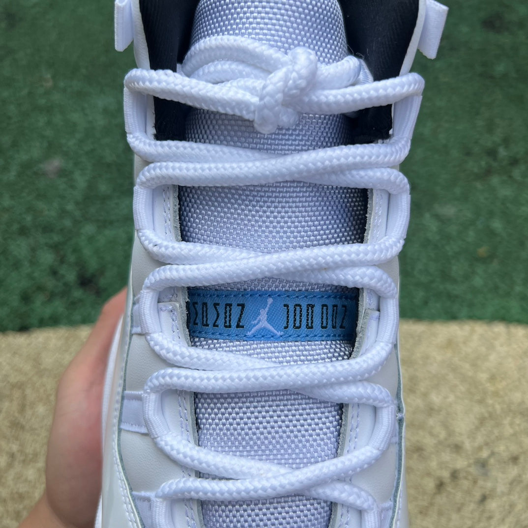 Nike Air Jordan 11 Retro Legend Blue sneakers in white and blue with patent leather and jumpman logo details.