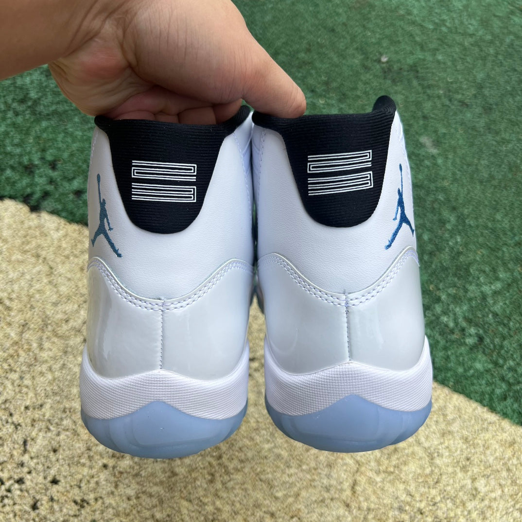 Nike Air Jordan 11 Retro Legend Blue sneakers in white and blue with patent leather accents, front view highlighting design details.
