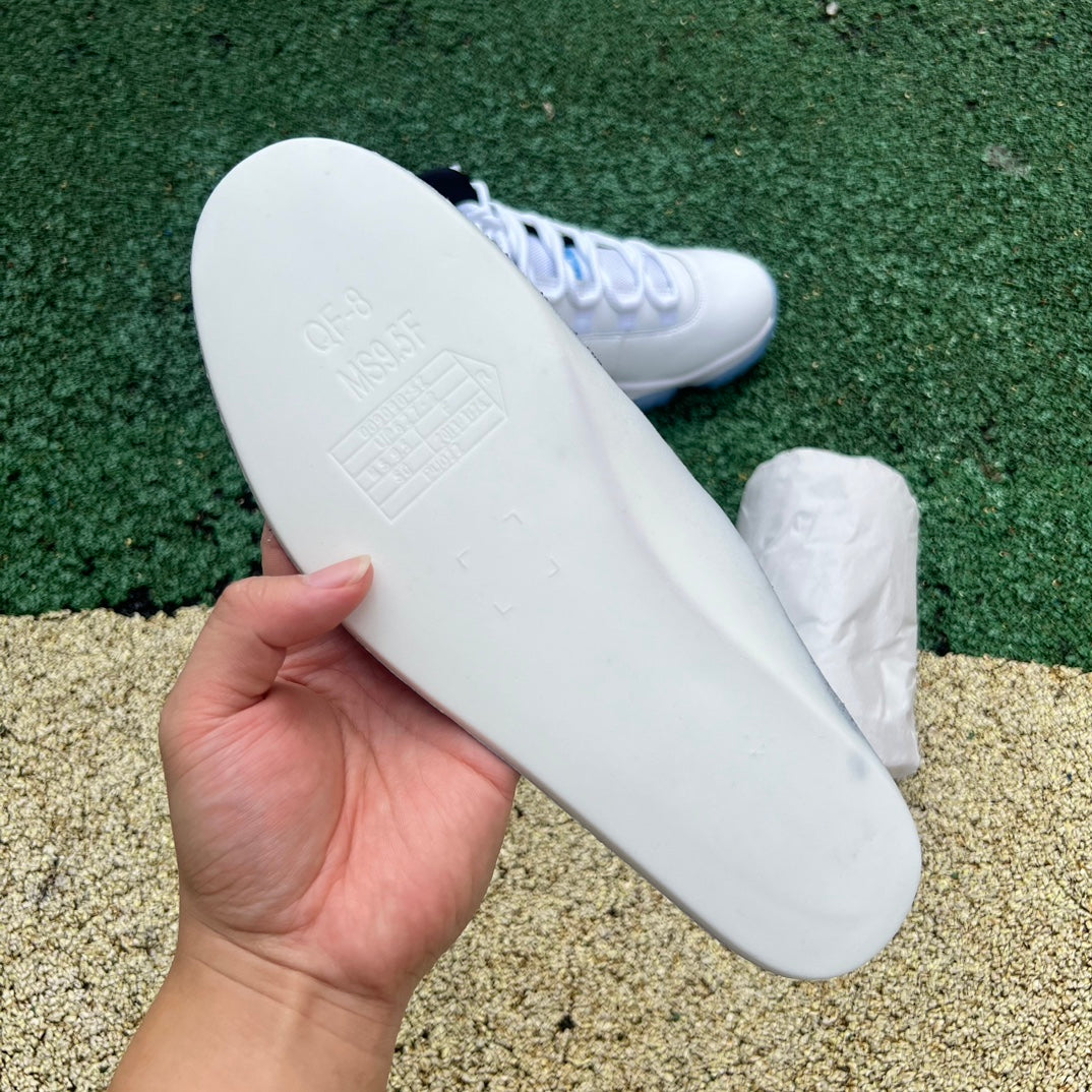 Nike Air Jordan 11 Retro Legend Blue sneakers in white and blue, featuring patent leather and iconic design details.