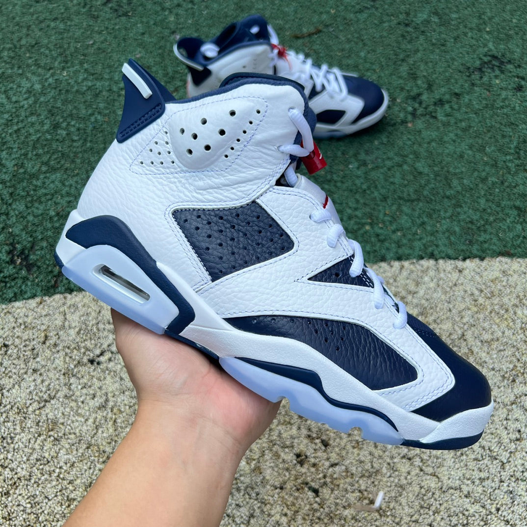 Nike Air Jordan 6 Retro Olympic sneakers in blue, white, and red with black accents, showcasing the classic basketball shoe design.