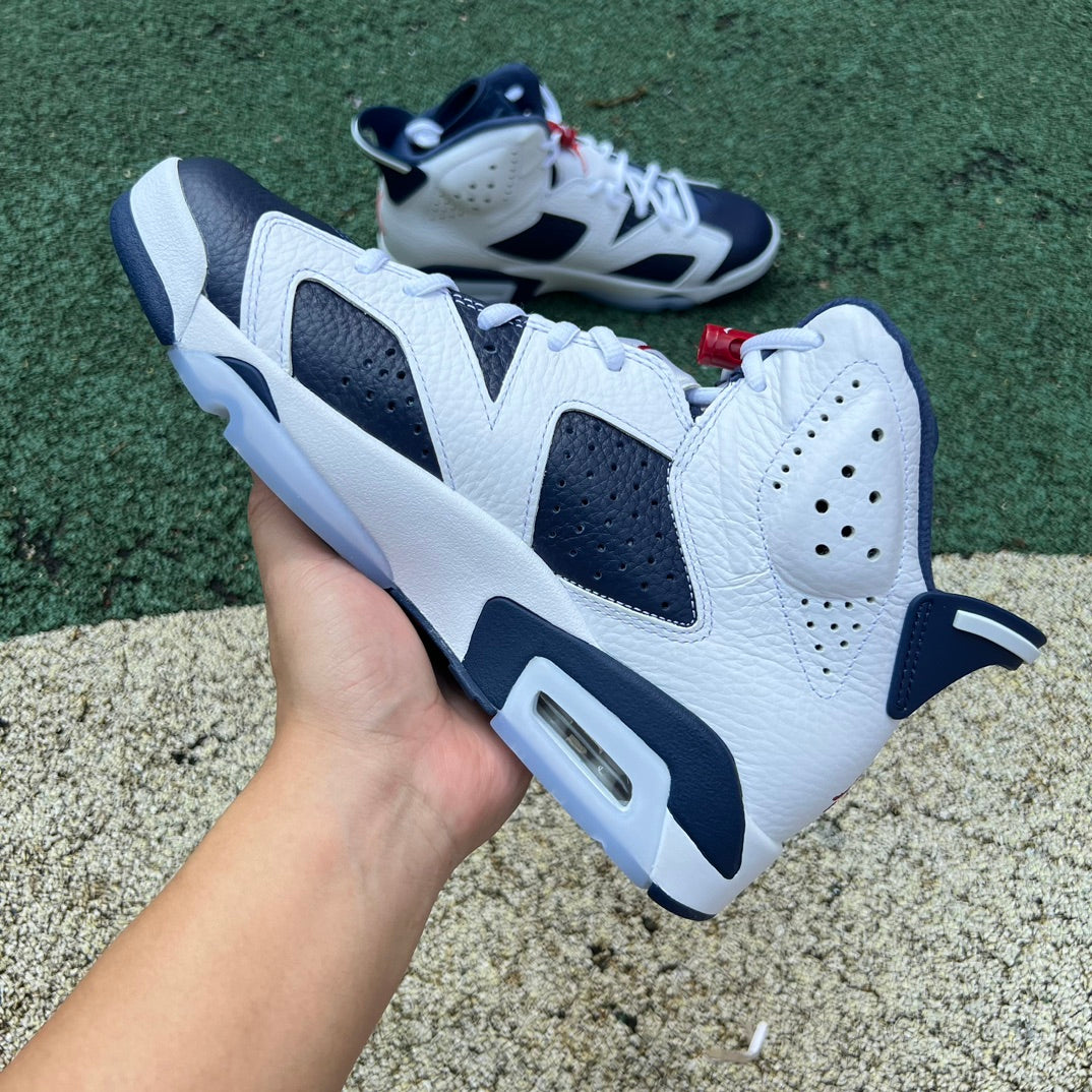 Nike Air Jordan 6 Retro Olympic sneakers in white, blue, red, and gold, featuring the iconic design and branding details.