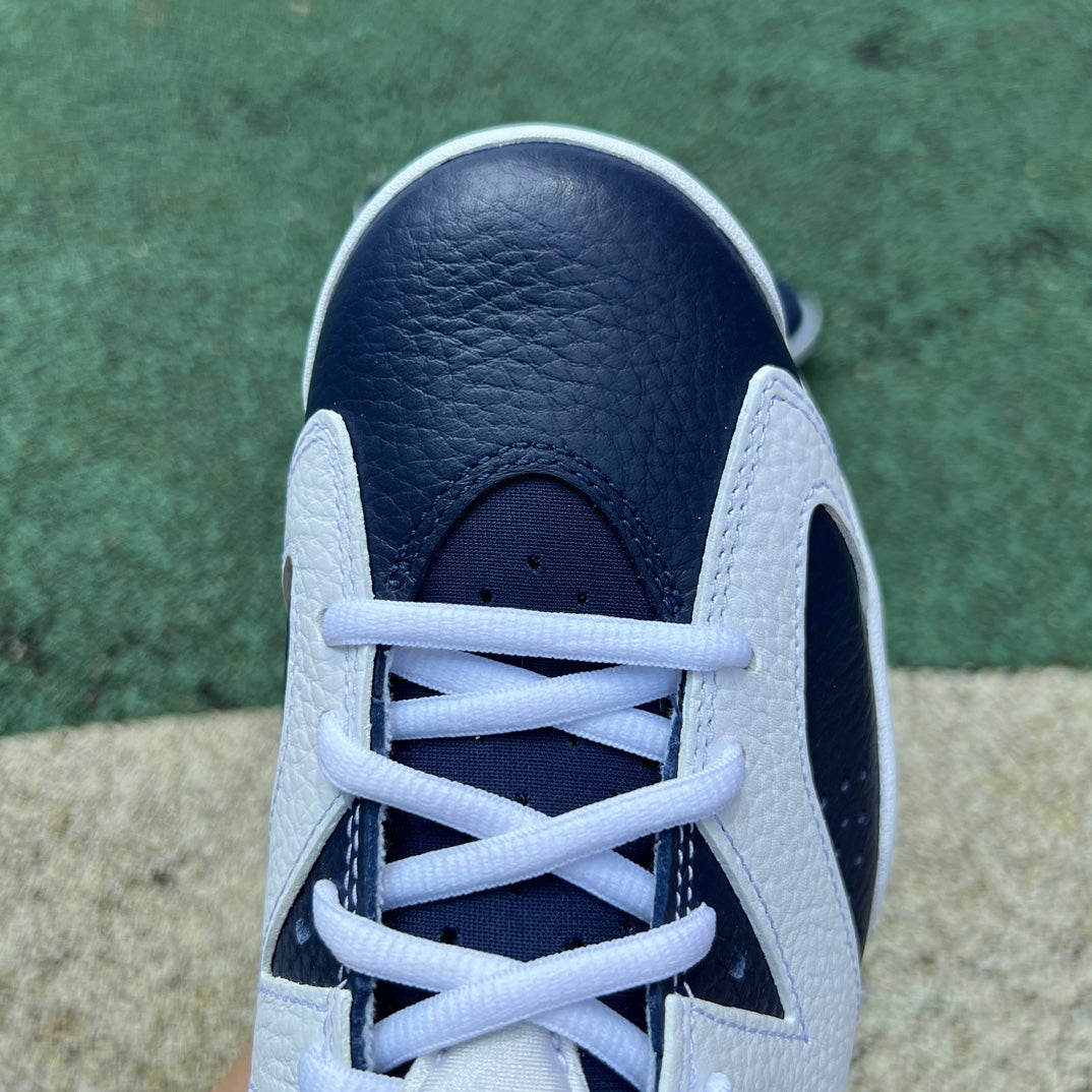 Nike Air Jordan 6 Retro Olympic sneakers in white, blue, and gold with Nike x Jordan branding and signature design details.