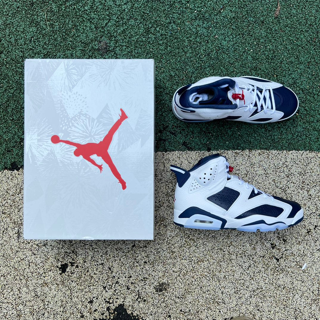 Nike Air Jordan 6 Retro Olympic sneakers in blue, white, and black with detailed design and Nike Jordan branding.