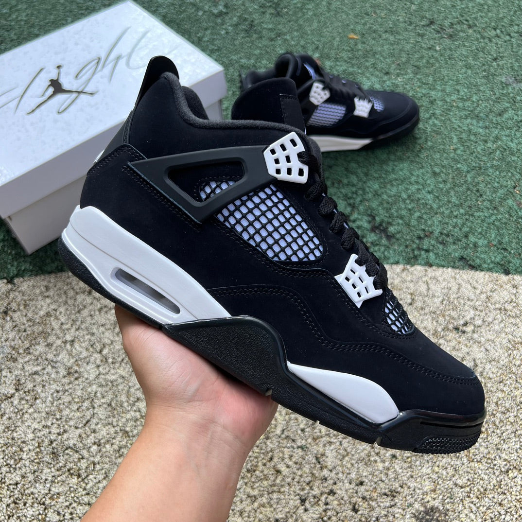 Nike Air Jordan 4 Retro White Thunder sneakers in white and yellow with black accents, viewed from the side.