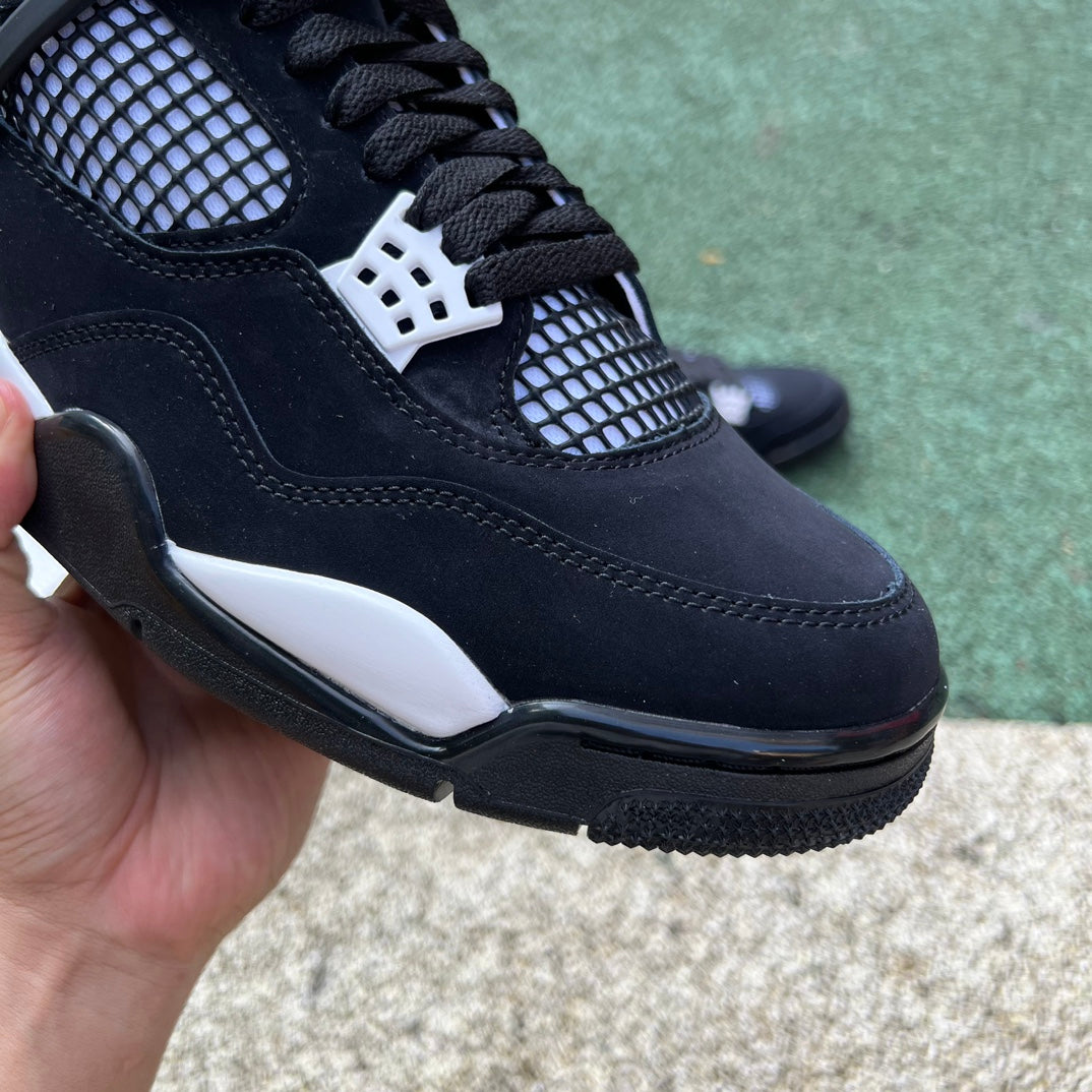 Nike Air Jordan 4 Retro White Thunder sneakers in white and yellow with black accents, showcasing the classic basketball shoe design.