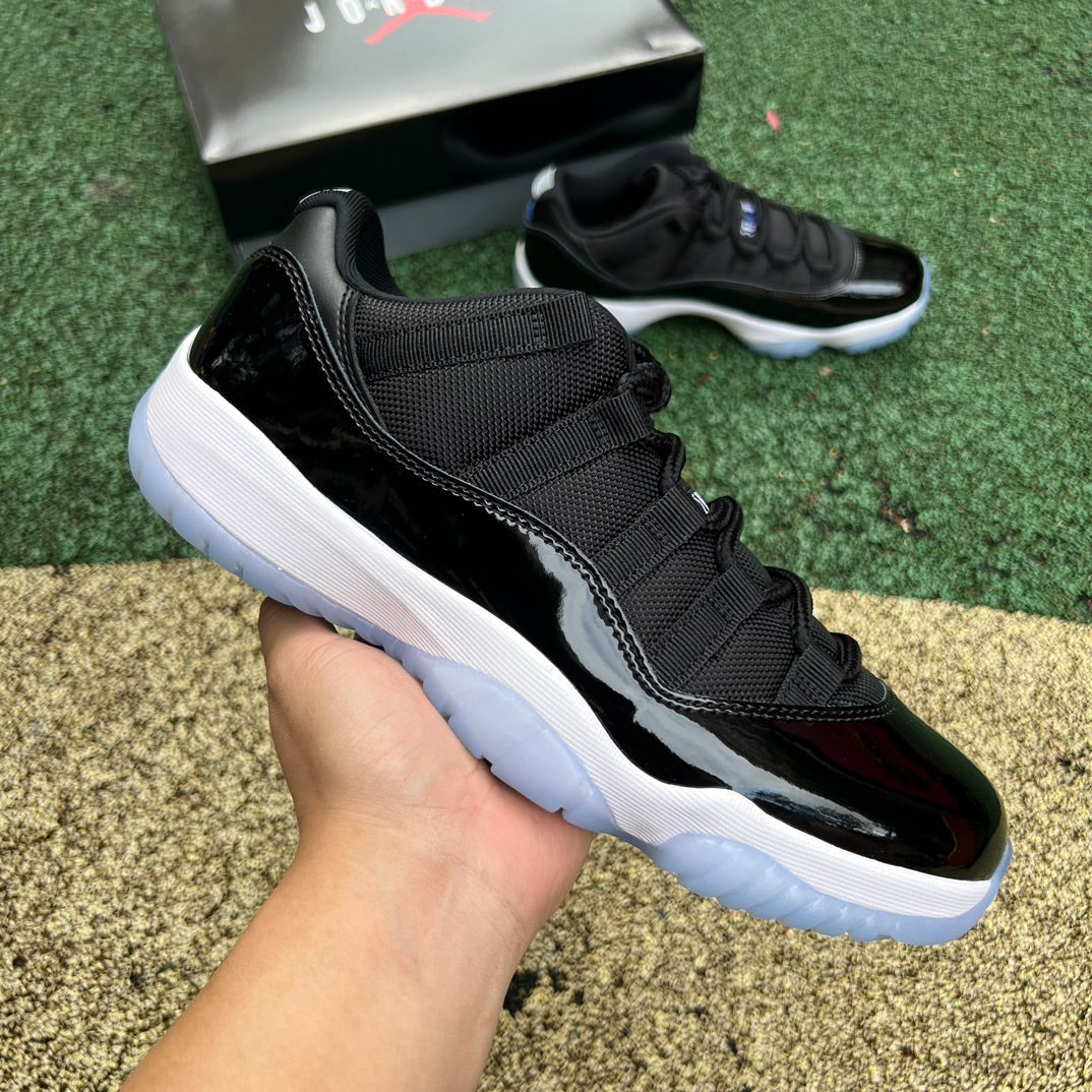 Nike Air Jordan 11 Retro Low Space Jam sneakers in black and blue with patent leather detailing and Jumpman logo.