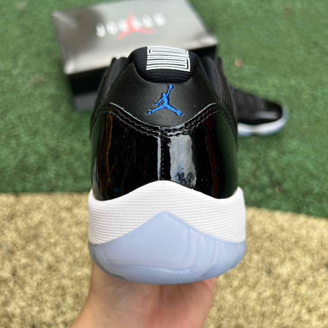 Nike Air Jordan 11 Retro Low Space Jam FV5104-004 sneakers featuring black patent leather and white upper with icy blue soles