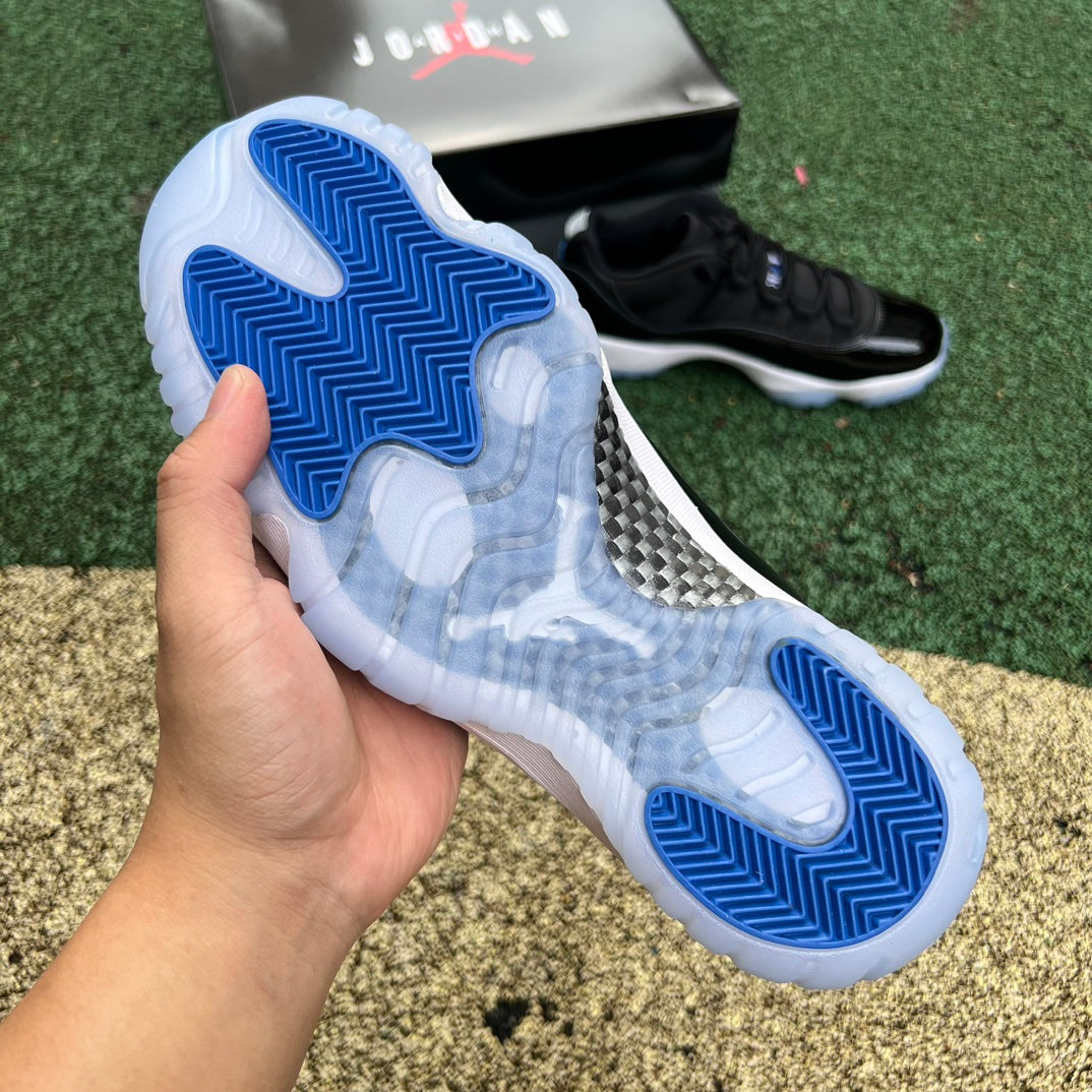 Nike Air Jordan 11 Retro Low Space Jam sneakers in black and white with patent leather, featuring Jumpman logo and icy blue outsole.