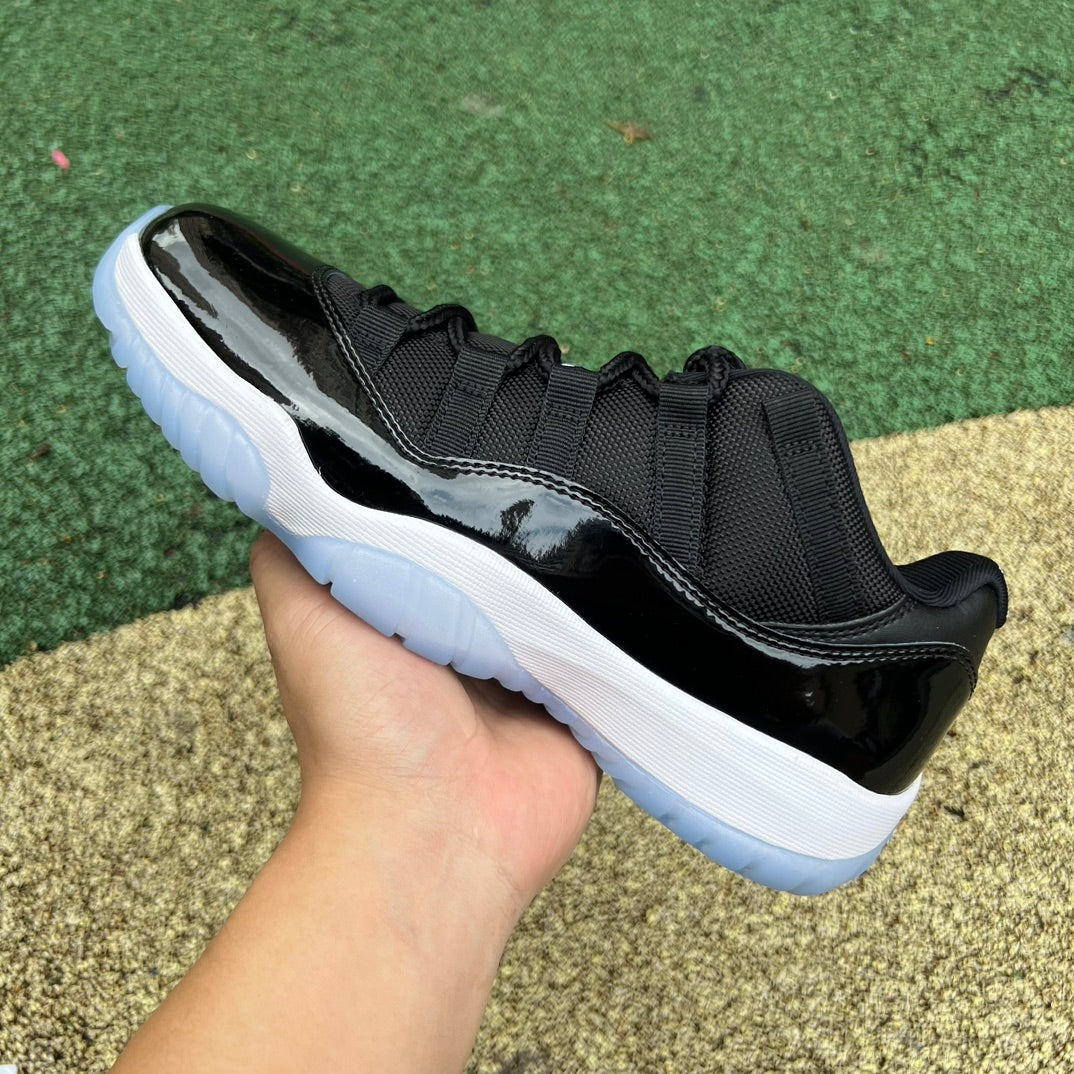 Nike Air Jordan 11 Retro Low Space Jam sneakers in black and blue with white accents, showcasing the iconic design and branding.