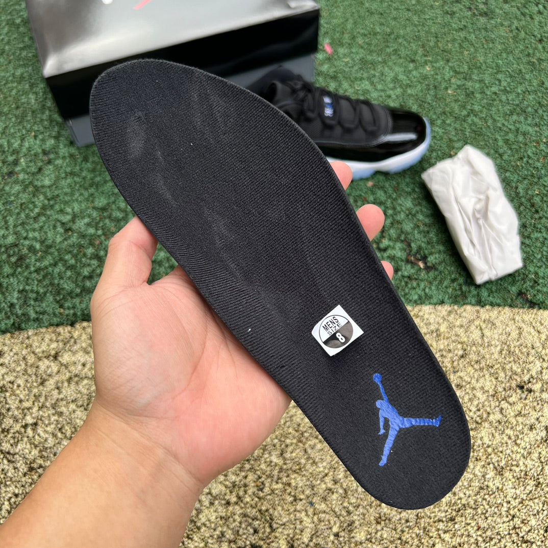 Nike Air Jordan 11 Retro Low Space Jam sneakers in black and white with glossy patent leather details.
